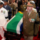 The coffin of South African former president Nelson Mandela is escorted inside the compound for his funeral ceremony in Qunu on Dec. 15, 2013.
ELMOND-JIYANE,ELMOND-JIYANE/AFP/Getty Images